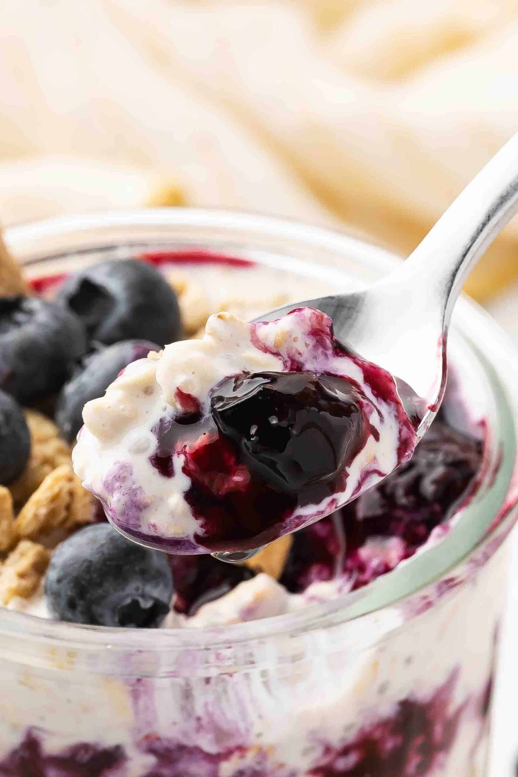 Close-up shot of Blueberry Overnight Oats scooped in a dessert spoon.