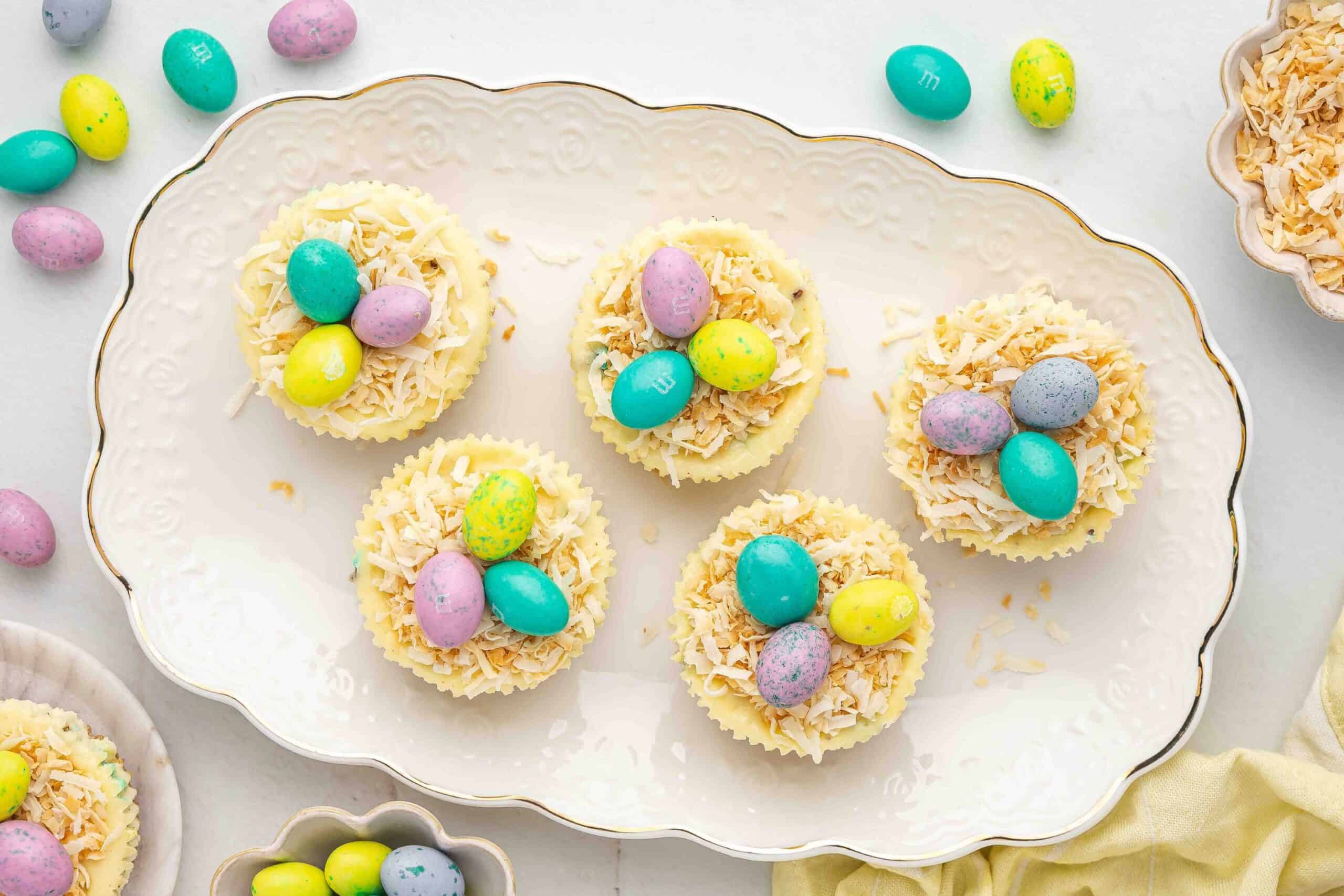 Mini Easter cheesecakes arranged on a platter with festive decorations