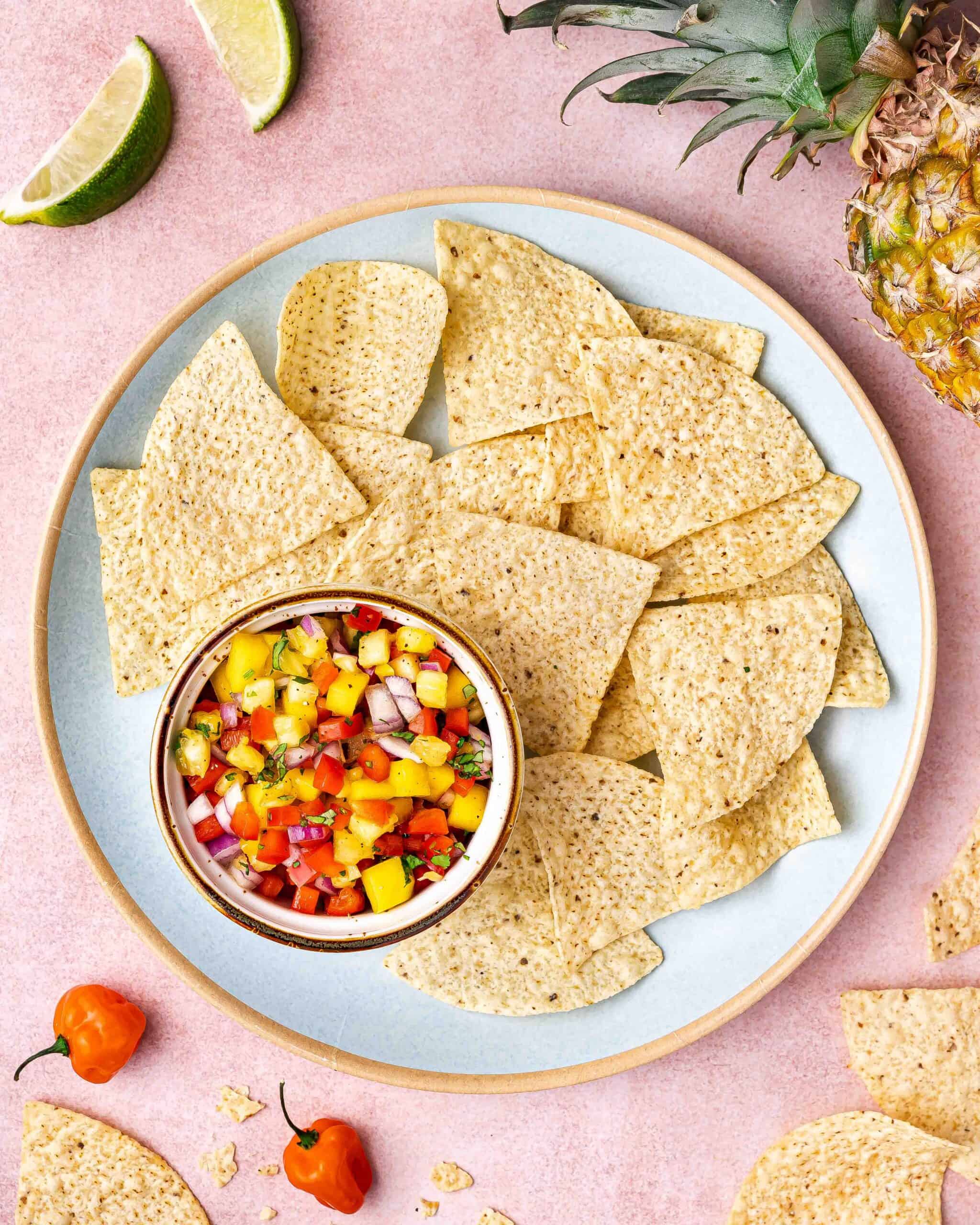 Bowl of Mango Pineapple Habanero Salsa next to tortilla chips.