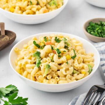 White bowl of mac and cheese with a rich cheesy texture