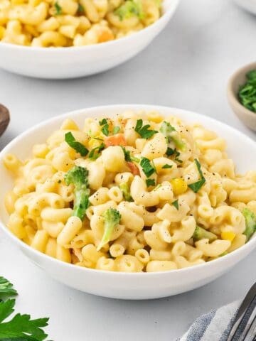 White bowl of mac and cheese with a rich cheesy texture