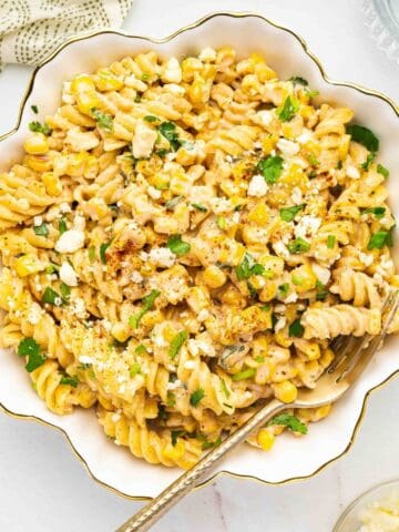 A large serving bowl filled with Mexican street corn pasta salad, perfect for sharing.