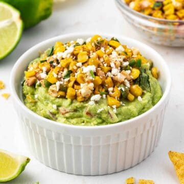 Mexican street corn guacamole served with crispy tortilla chips and fresh cilantro.