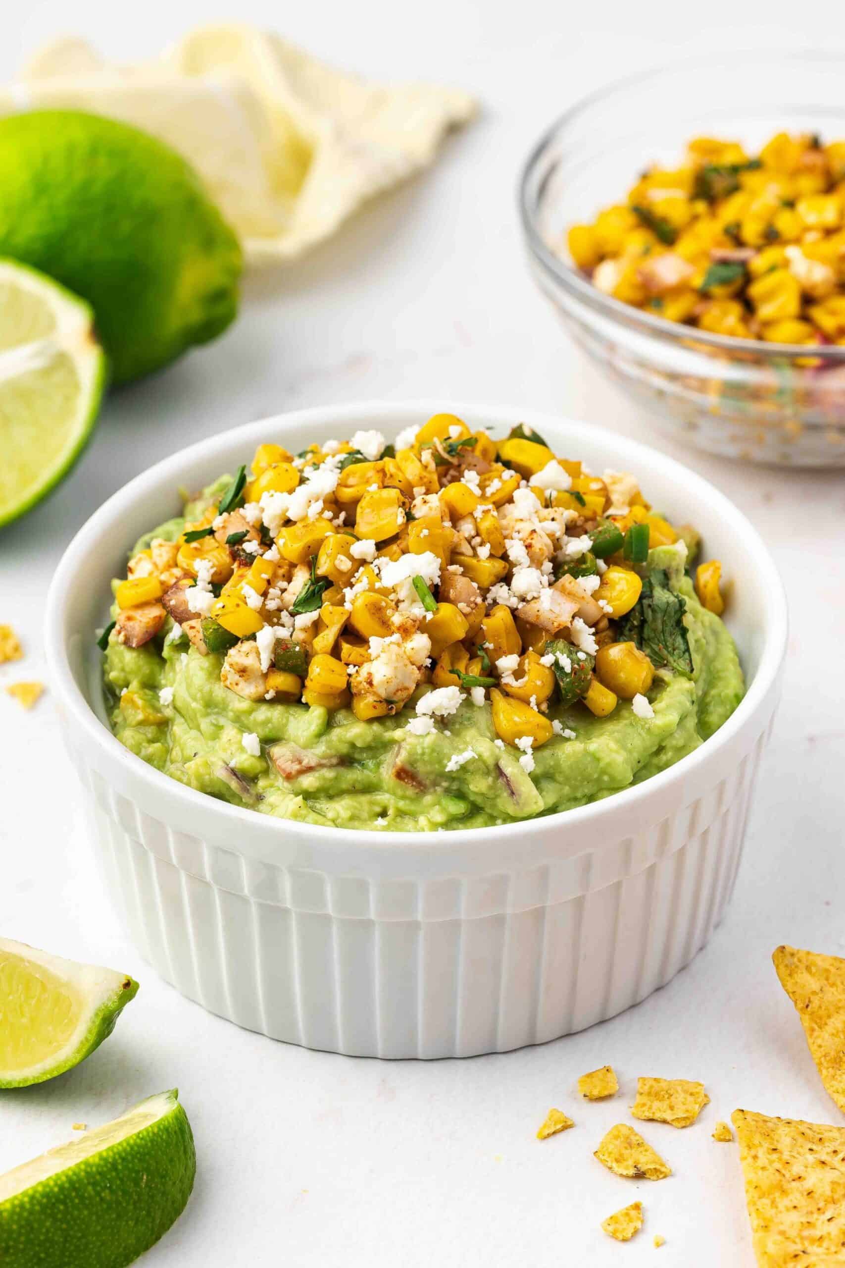 Mexican street corn guacamole served with crispy tortilla chips and roasted corn topping.