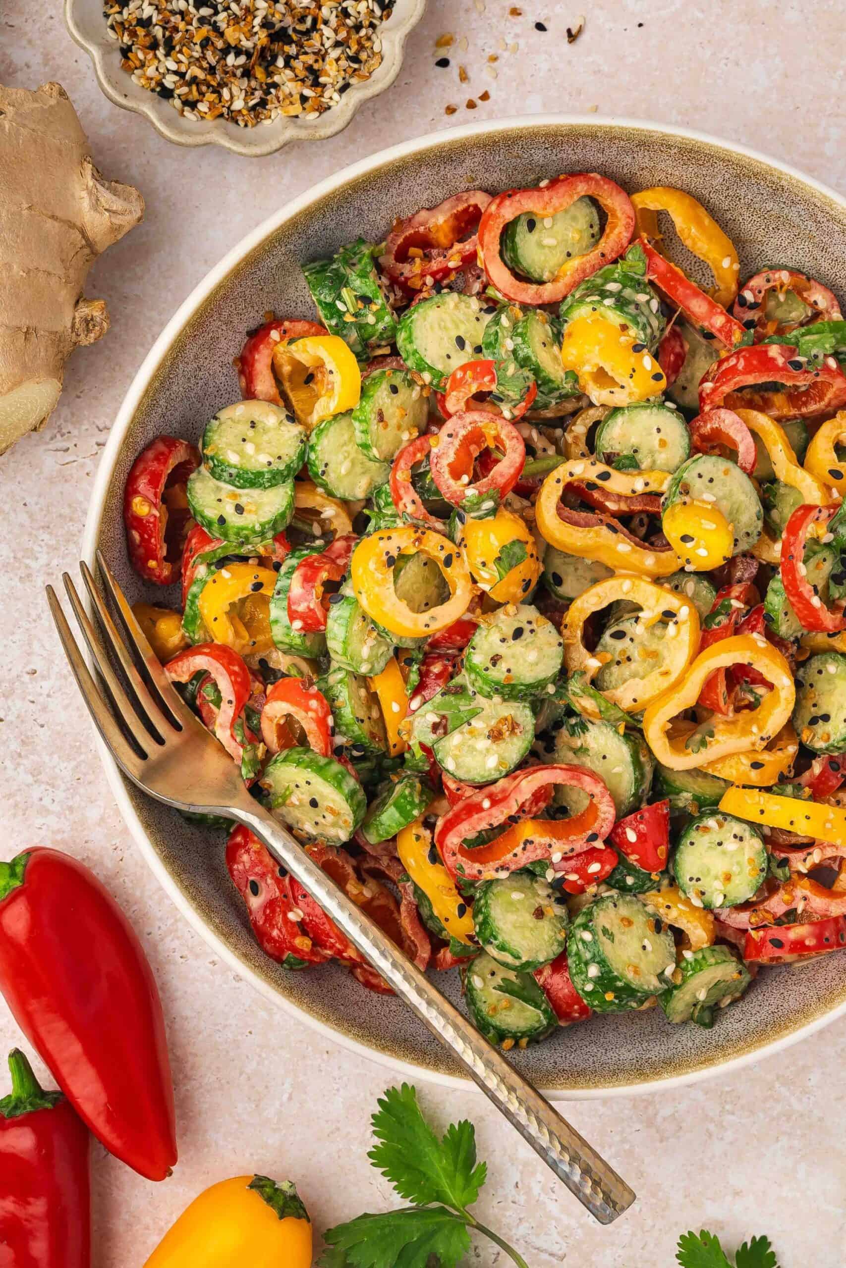 Colorful cucumber and bell pepper salad with herbs
