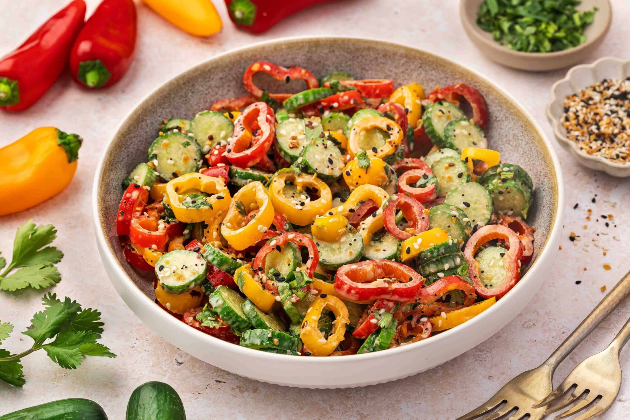 Colorful salad with cucumber, mini peppers, and tangy ginger dressing