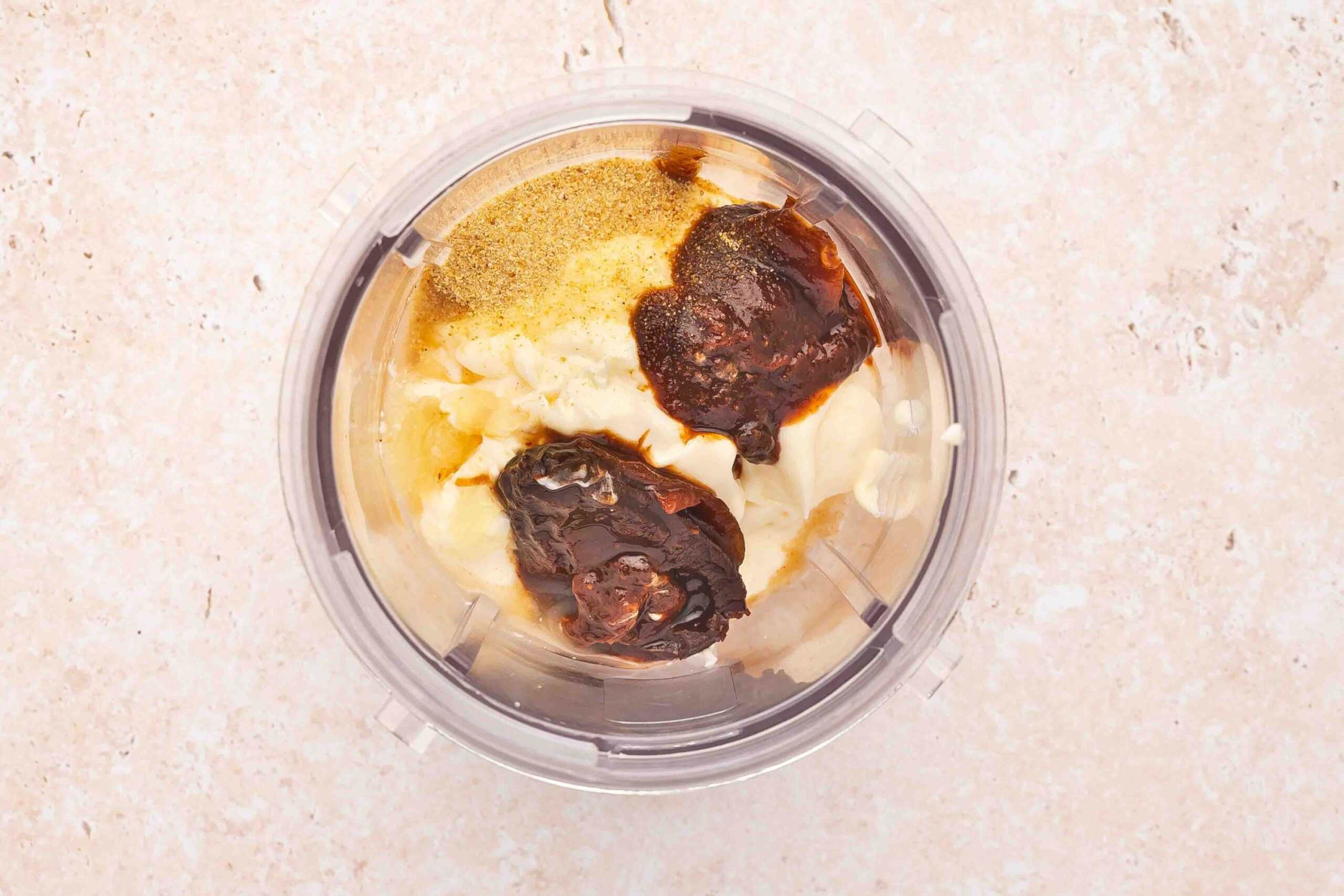 Mayonnaise, chipotle pepper, adobo sauce, lime juice, and salt added to a blender jar