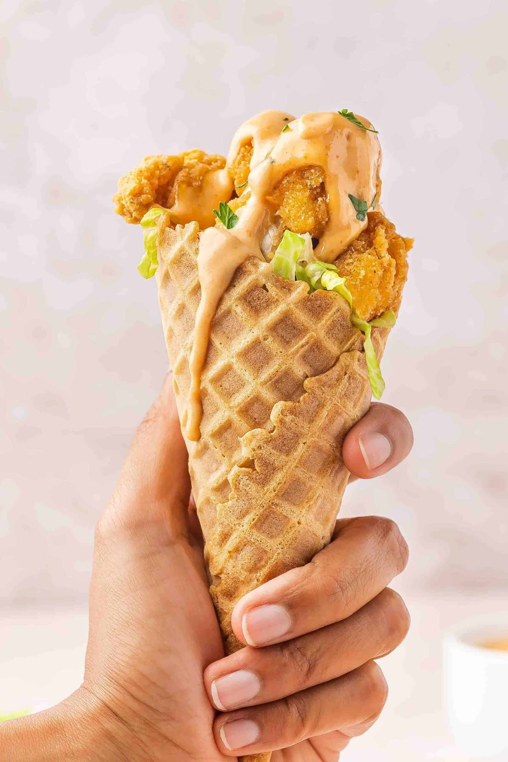 Chicken waffle cone held in hand, perfect for party food