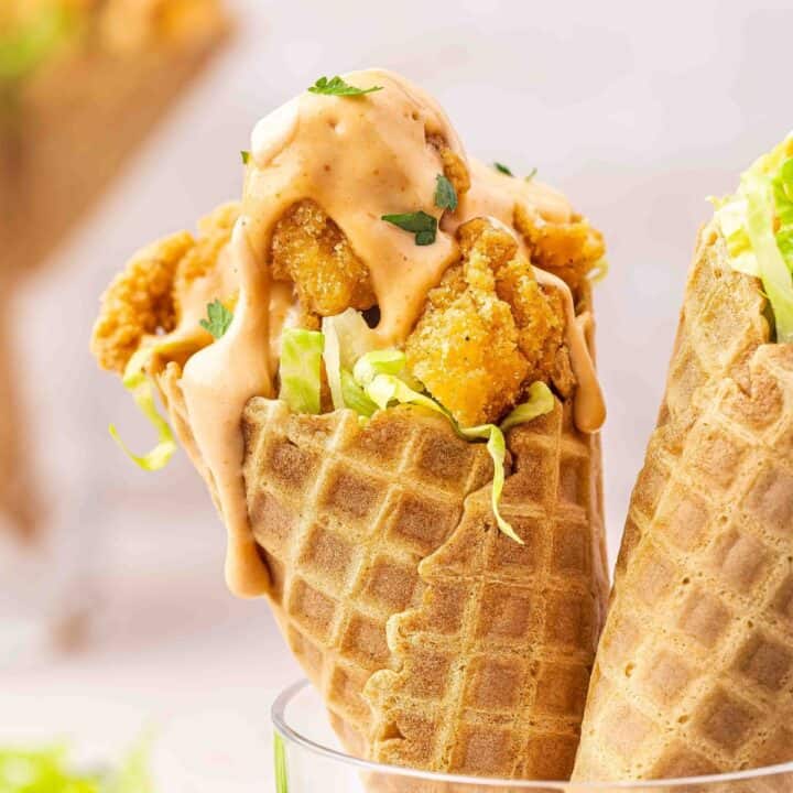 Spicy chicken waffle cones topped with creamy sriracha sauce and cilantro