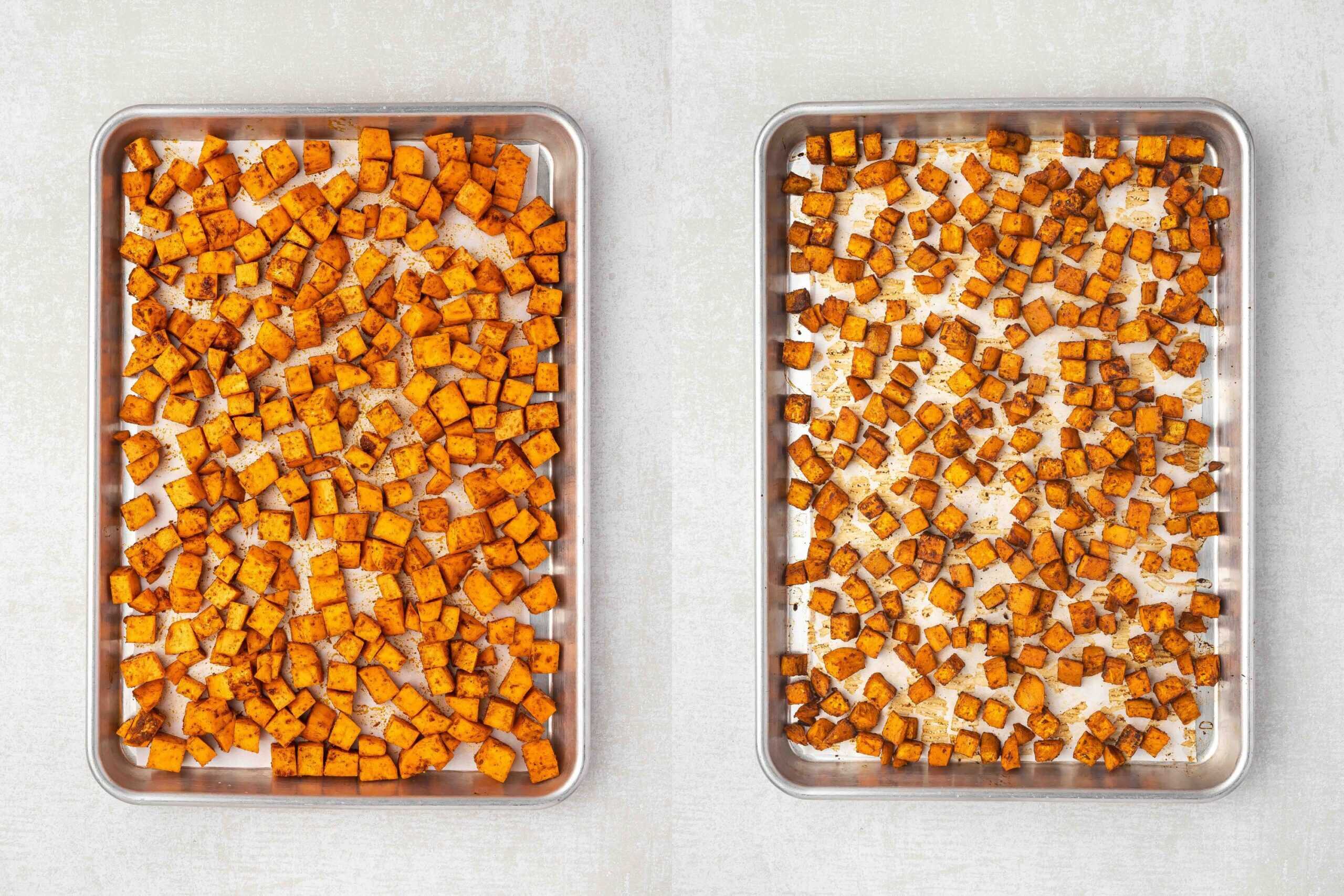 Seasoned sweet potato cubes spread in a single layer on a parchment-lined baking sheet.