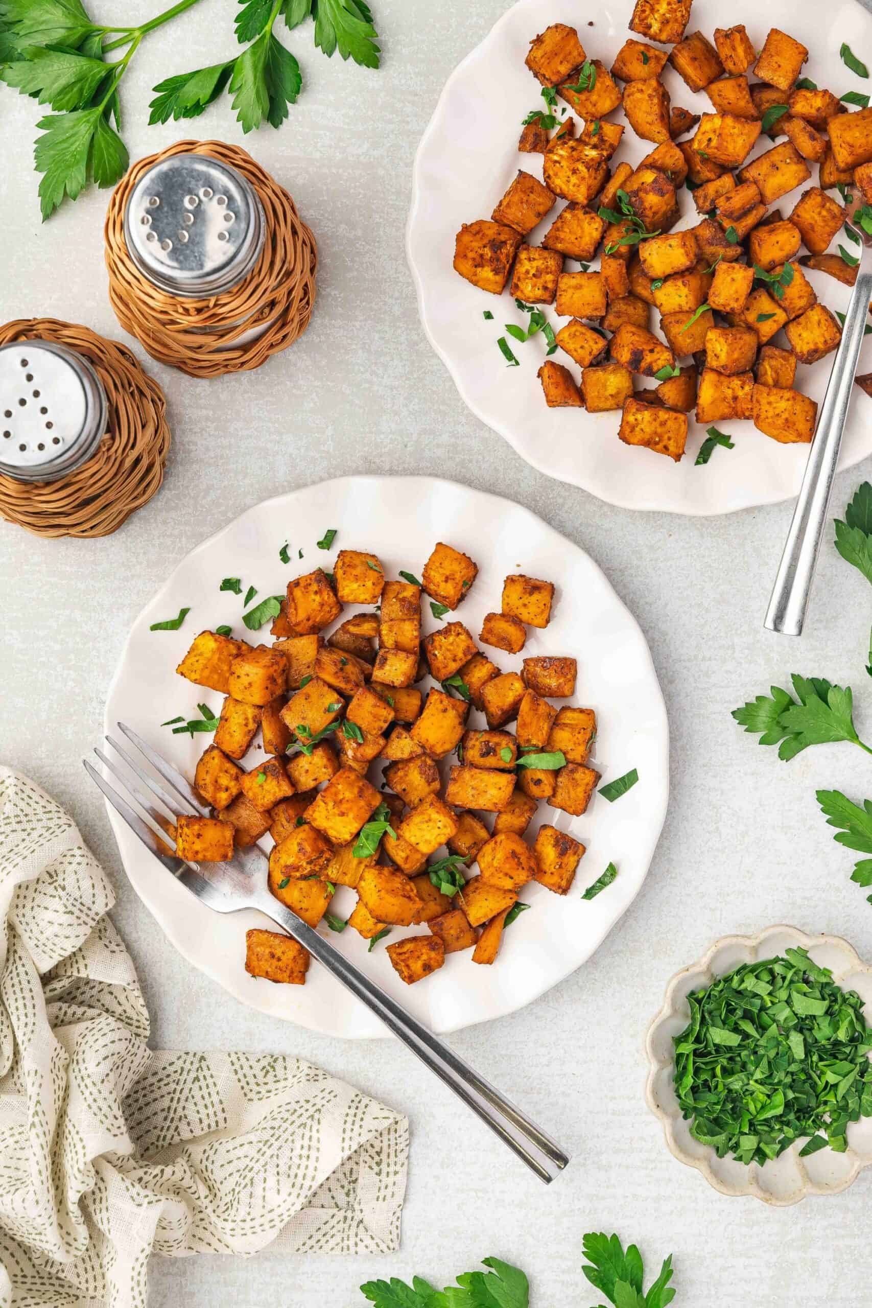 Overhead shot of crispy sweet potatoes arranged neatly on a round plate.
