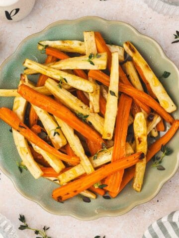 Golden roasted parsnips and carrots drizzled with honey and sprinkled with fresh thyme