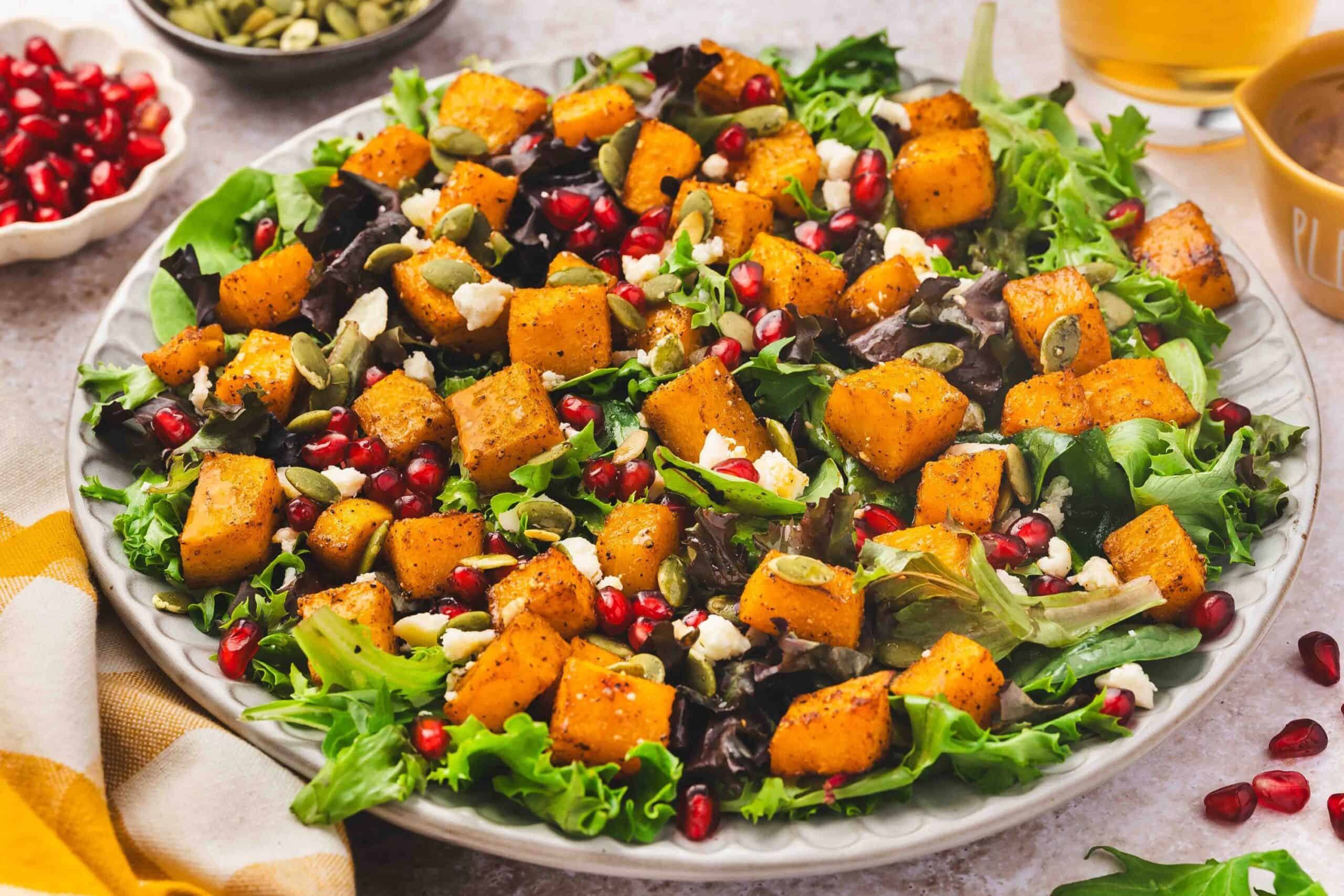 Roasted butternut squash cubes with feta and pumpkin seeds in a salad bowl