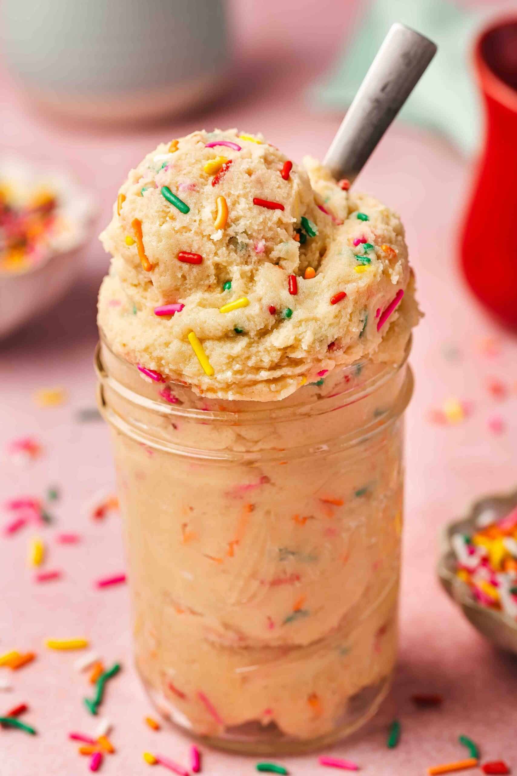 Funfetti edible sugar cookie dough in a glass jar, perfect for gifting or snacking.