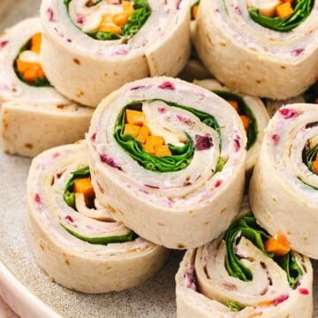 Turkey and veggie roll-ups with creamy cranberry filling, perfect for a healthy lunch wrap.