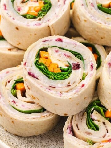 Turkey and veggie roll-ups with creamy cranberry filling, perfect for a healthy lunch wrap.