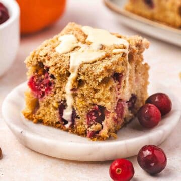 Freshly baked cranberry orange coffee cake topped with golden streusel and orange glaze