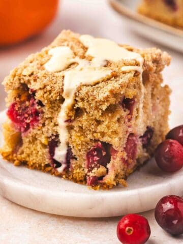 Freshly baked cranberry orange coffee cake topped with golden streusel and orange glaze