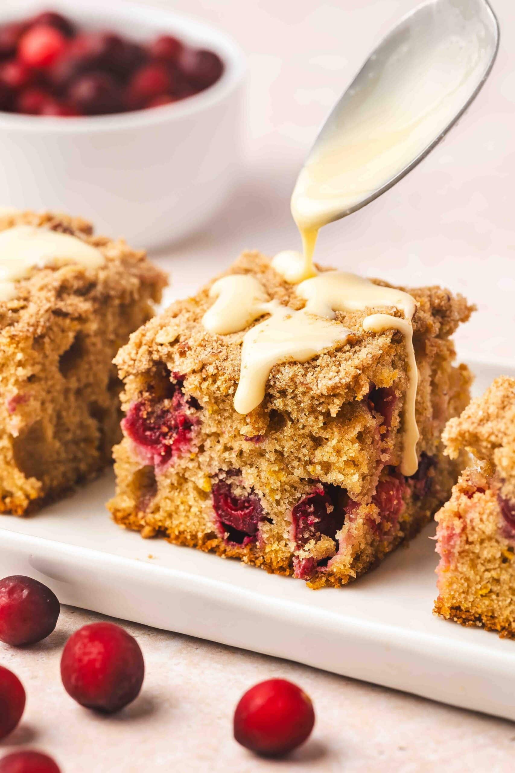 Coffee cake with cranberries and orange zest served with a cup of coffee