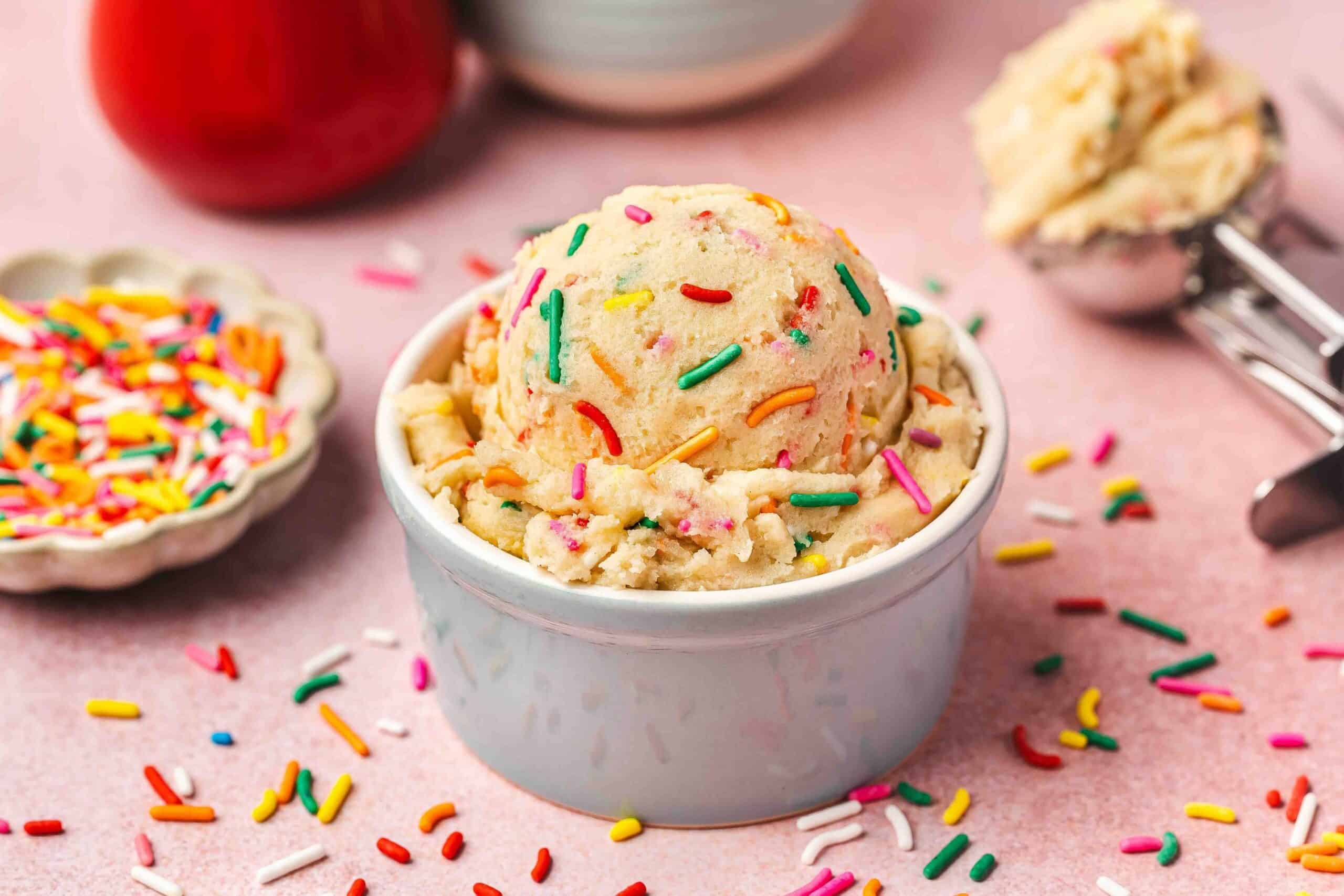 Edible sugar cookie dough in a neutral ceramic bowl, soft and creamy texture visible.