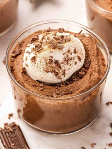 Rich, creamy chocolate mousse in 6–8 oz cups with decorative cocoa topping